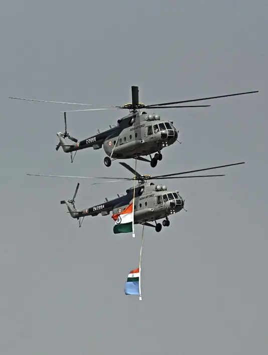 Helikopter Angkatan Udara India tampil pada hari pertama Aero India 2021 Airshow di Stasiun Angkatan Udara Yelahanka, Bangalore, India, Rabu (3/2/2021). Aero India 2021 akan berlangsung selama tiga hari dam berfokus pada kemampuan sektor pertahanan asli India. (Jewel SAMAD/AFP)
