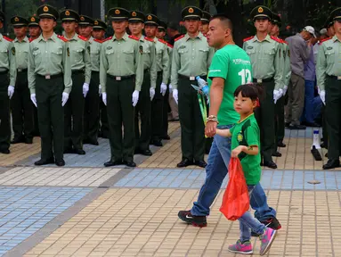 Seorang ayah mengajak anaknya menyaksikan laga klub Beijing Guoan FC yang merupakan peserta kompetisi Liga Super China. (EPA/Wu Hong)