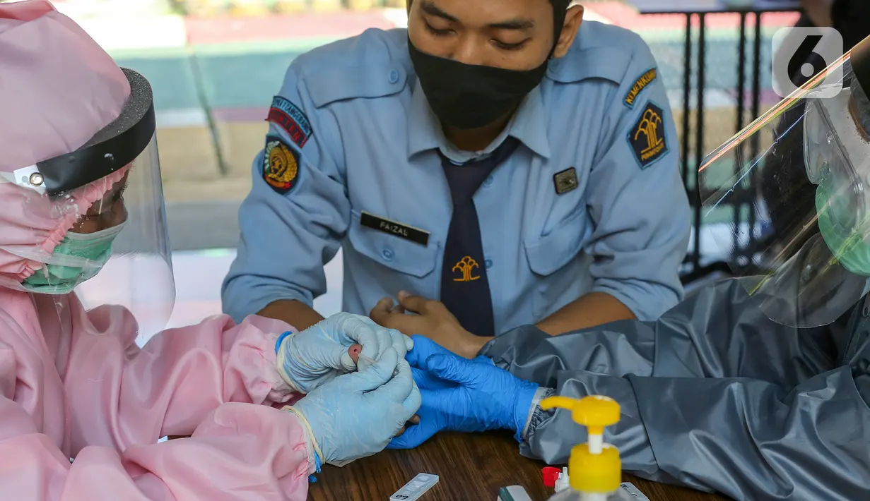 Tenaga medis mengambil sampel darah Pegawai Lapas Kemenkumham menjalani rapid test di Lembaga Pembinaan Khusus Anak (LPKA) Klas I Tangerang, Banten, Sabtu (30/5/2020). Hasil rapid test Covid-19 yang diikuti 87 pegawai diserahkan ke Kanwil Kemenkumham Banten. (Liputan6.com/Fery Pradolo)