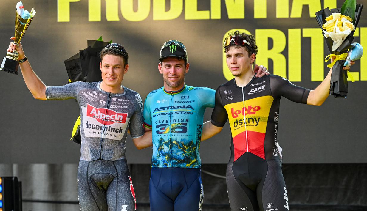 Pembalap sepeda Astana Qazaqstan, Mark Cavendish (tengah) berfoto bersama dengan Jasper Philipsen (kiri) dan Arnaud De Lie saat memenangkan Tour de France Criterium di Singapura pada Minggu, 10 November 2024. (AFP/Roslan Rahman)