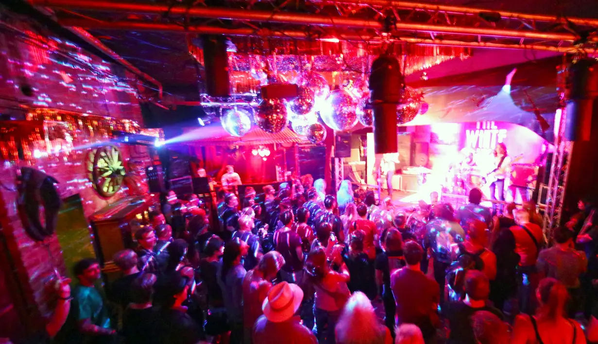 Para pengunjung saat menikmati penampilan aksi band rock di Bassy Club, Berlin, Jerman, (30/8). Kelab malam ini menampilkan perpaduan Blues, Soul, Negara, Rock'n'Roll dan banyak lagi. (REUTERS/Hannibal Hanschke)