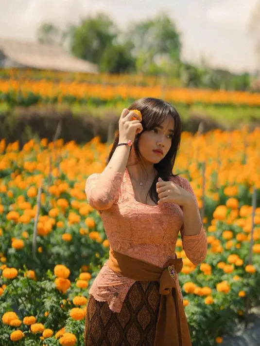 Fuji tampil mengenakan kebaya bergaya wanita Bali. Kebaya brokat tersebut memiliki lengan panjang. Tampilannya ini memerlihatkan body goalsnya. [@fuji_an]