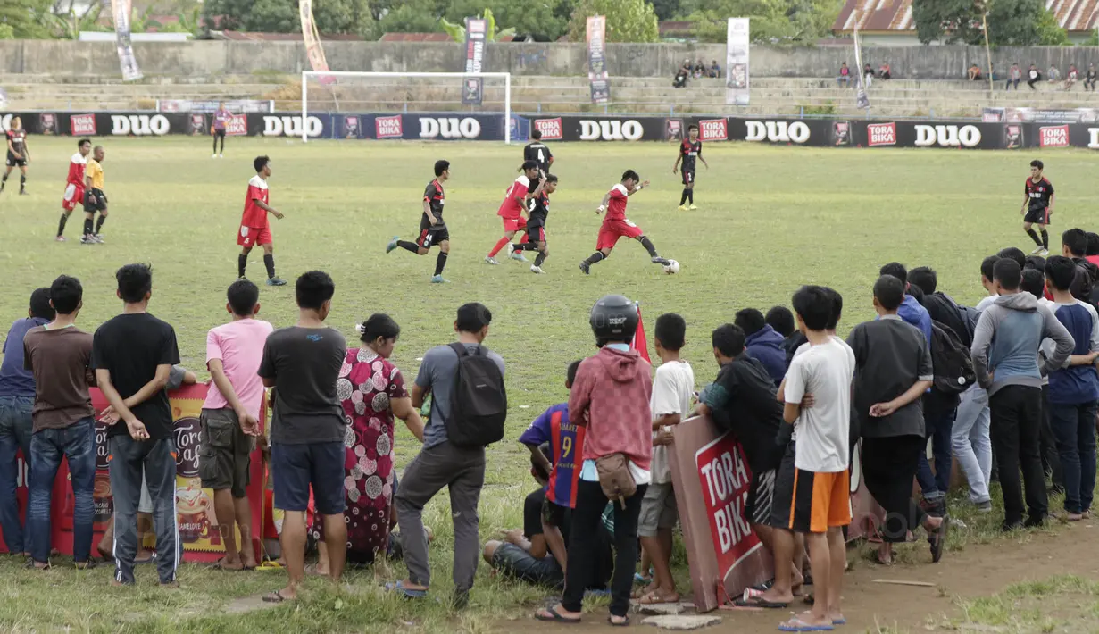 Warga menonton pertandingan antara STIMED Nusa Palapa melawan STKIP Mega Resky pada final Torabika Campus Cup 2017 di Stadion UNM, Makassar, Kamis, (19/10/2017). STIMED Nusa Palapa menang adu penalti atas STKIP Mega Resky. (Bola.com/M Iqbal Ichsan)