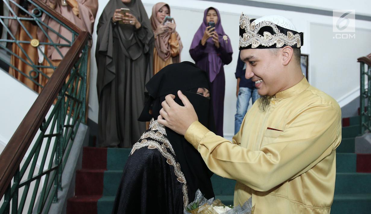 Pesinetron Egi John bersama istri, Kamilia Yasmin usai malangsungkan pernikahan di kawasan Cinere, Jakarta, Sabtu (1/7). Hubungan Egi dengan Mia sendiri terjadi melalui proses taaruf selama tiga bulan belakangan ini. (Liputan6.com/Herman Zakharia)