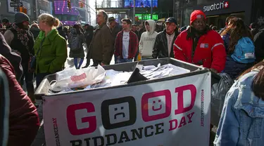 Tempat sampah yang penuh kertas berisi kenangan pahit selama kegiatan Good Riddance Day ke-13 tahunan di Times Square, New York, 28 Desember 2019. Kegiatan menjelang tahun baru tersebut menjadi tradisi untuk menghapus kenangan buruk selama satu tahun. (Kena Betancur / AFP)
