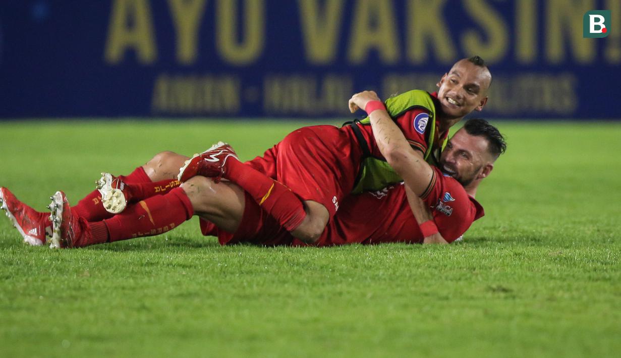 Pemain Persija Jakarta, Riko Simanjuntak (atas) dan Marko Simic merayakan kemenangan 1-0 atas Persib Bandung dalam laga pekan ke-12 BRI Liga 1 2021/2022 di Stadion Manahan, Solo, Sabtu (20/11/2021). (Bola.com/Bagaskara Lazuardi)