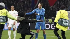 Seorang penggemar berlutut di depan penyerang Cristiano Ronaldo selama pertandingan antara Lyon dan Juventus pada leg pertama babak 16 Liga Champions di Stadion Olimpiade Lyon di Decines, Prancis (26/2/2020). Dalam pertandingan ini Lyon berhasil mengalahkan Juventus 1-0. (AP Photo/Laurent Cipriani)