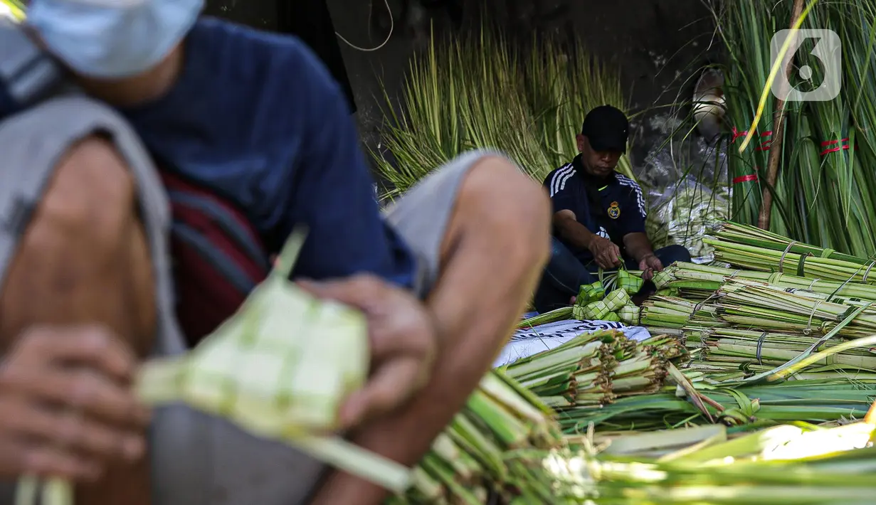 Pedagang membuat cangkang ketupat di kawasan Palmerah, Jakarta, Minggu (18/7/2021). Pemberlakuan PPKM Darurat membuat penjualan cangkang ketupat jelang Idul Adha tahun ini sepi pembeli. (Liputan6.com/Faizal Fanani)