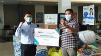 General Manager Garuda Indonesia Cabang Mamuju, Hendri Thomassawa menyerahkan bantuan Garuda Indonesia Pedulu ke Ketua Satgas Bencana BUMN Sulawesi Barat (Foto: Liputan6.com/Abdul Rajab Umar)