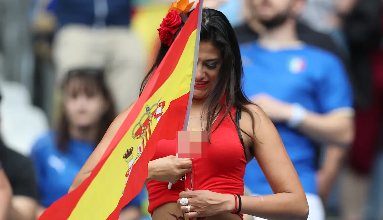 Suporter wanita pendukung Spanyol membawa bendera saat akan menyaksikan babak 16 besar Piala Eropa 2016 antara Italia vs Spanyol, Stade de France, Senin (27/6). (REUTERS/ Lee Smith) 