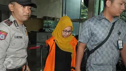 Direktur Keuangan PT Berdikari Siti Marwa dikawal petugas meninggalkan KPK, Jakarta, Kamis (26/5). Siti Marwa kembali diperiksa sebagai tersangka kasus suap pengadaan pupuk urea di PT Berdikari (Persero) periode tahun 2010-2012 (Liputan6.com/Helmi Afandi)