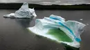 Pemandangan gunung es terapung di King's Point, Newfoundland, Kanada, 3 Juli 2019. Gunung es terapung tersebut dapat mencapai berat hingga ratusan ribu ton. (Johannes Eisele/AFP)