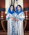 Annisa Pohan dan Aliya Rajasa pun tampil kembar mengenakan dress panjang lengan puffer. Dress satin warna dasar putih tersebut memiliki motif floral biru. [@annisayudhoyono]