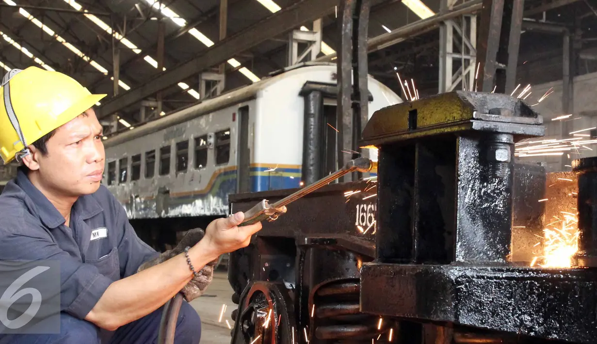 Seorang pekerja menyelesaikan perbaikan gerbong kereta api di Balai Yasa, Manggarai, Jakarta, Rabu (1/7/2015). PT KAI menyiapkan 30 perjalanan kereta api tambahan untuk mengangkut para pemudik jelang Lebaran. (Liputan6.com/Helmi Afandi)