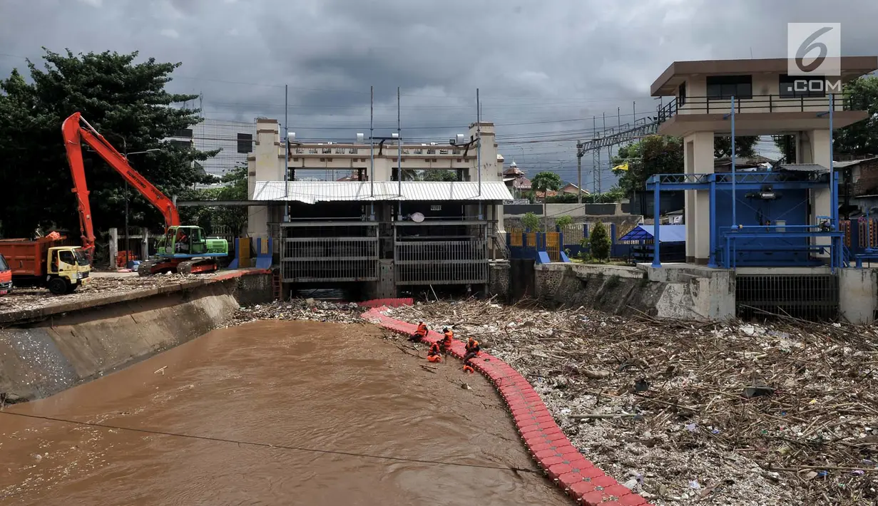 Petugas Dinas Lingkungan Hidup Pemprov DKI saat membersihkan sampah yang memenuhi sekitar Pintu Air Manggarai, Jakarta, Minggu (8/4). Sebanyak 312 meter kubik sampah ranting pohon dan plastik styrofoam memenuhi pintu air. (Merdeka.com/Iqbal Nugroho)