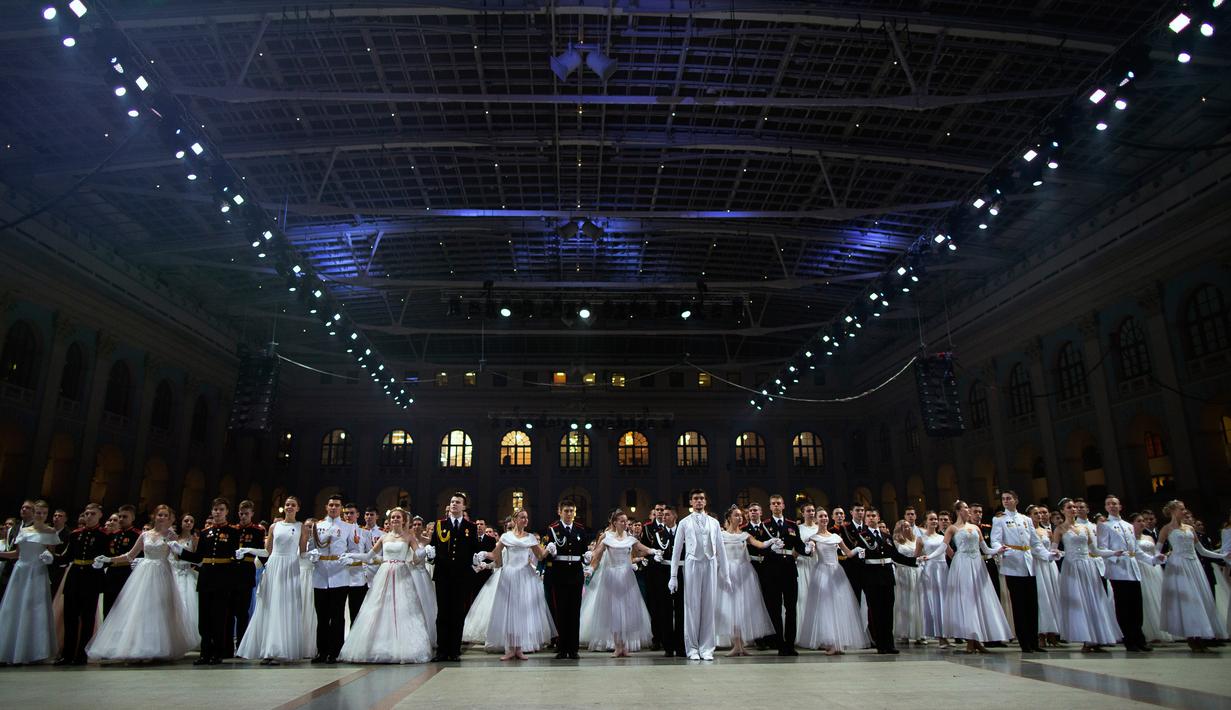 Para siswa sekolah militer bersiap untuk menari saat pesta tahunan Cadet Ball di Moskow, Rusia, Selasa (17/12/2019). Dalam acara ini para peserta mengenakan seragam dan gaun sambil menari tradisional dengan alunan musik klasik. (AP Photo/Alexander Zemlianichenko)