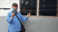 Karyawan PT Langgam Harmuni melihatkan bukti perusakan barak pada tahun lalu. (Liputan6.com/M Syukur)