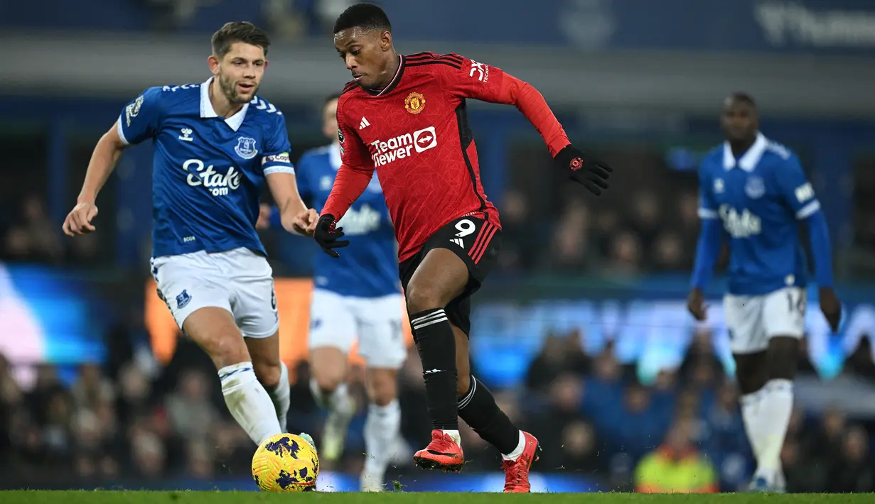 Pemain MU, Anthony Martial (tengah), berhasil mencetak gol ketiga ke gawang Everton dalam pertandingan lanjutan Liga Inggris 2023/2024 yang berlangsung di Goodison Park Stadium, Liverpool, Senin (27/11/2023) dini hari WIB. (AFP/Paul Ellis)