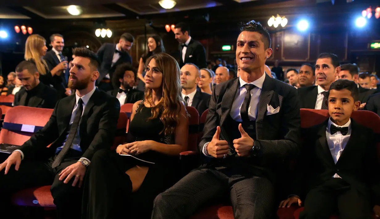 Bintang Real Madrid, Cristiano Ronaldo dan putranya, Cristiano Ronaldo Jr, duduk di samping bintang Argentina, Lionel Messi serta sang istri, Antonella, dalam acara The Best FIFA Football Awards 2017 di London, Inggris, Senin (23/10). (AP/Alastair Grant)