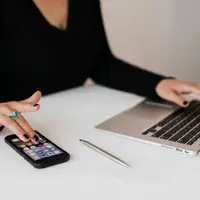 Multitasking/copyright Pexels.com https://www.pexels.com/photo/crop-woman-using-smartphone-and-laptop-during-work-in-office-4467737/