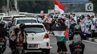 Masyarakat membawa bendera Palestina di jalan Basuki Rahmat, Jakarta, Kamis (20/5/2020). Aksi masyarakat tersebut untuk mengutuk penyerangan Israel ke Palestina yang telah menyebabkan ratusan korban jiwa. (Liputan6.com/Johan Tallo)