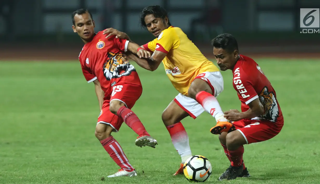 Pemain sayap Selangor FA, Ilham Udin Armaiyn (tengah) berebut bola dengan dua pemain Persija, Riko Simanjuntak (kiri) dan Ramdani Lestaluhu saat laga persahabatan di Stadion Patriot Candrabhaga, Bekasi, Kamis (6/9). (Liputan6.com/Helmi Fithriansyah)
