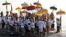 Umat Hindu saat mengikuti upacara doa Melasti di salah satu pantai di Denpasar, Bali, pada Senin 16 Maret 2026. Rangkaian upacara menyambut Hari Raya Nyepi Tahun Baru Saka 1948 di sejumlah wilayah di pulau Bali mulai dilaksanakan dengan prosesi melasti di sejumlah pantai dan sumber mata air. (SONNY TUMBELAKA/AFP)