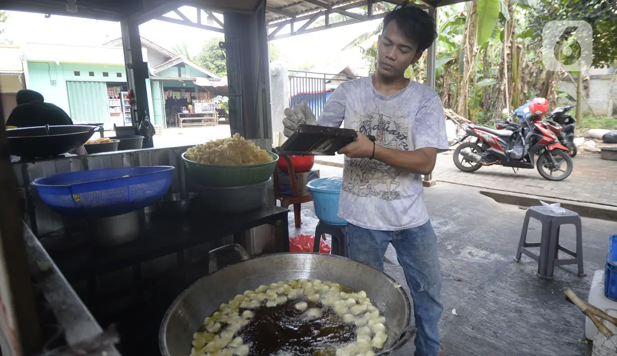 Pekerja menyerut dan langsung menggoreng keripik singkong rumahan di Kampung Kopi, Gunung Sindur, Bogor, Jawa Barat, Selasa (8/9/2020). Camilan yang dijual dengan harga Rp 8 ribu hingga Rp 50 ribu tergantung rasa tersebut banyak diminati warga di masa pandemi. (merdeka.com/Dwi Narwoko)