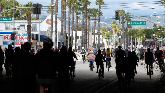 Orang-orang mengendarai sepeda di jalan-jalan bebas kendaraan bermotor selama acara CicLAvia di Culver City, Los Angeles, Minggu (3/3). Di Los Angeles, car free day disebut juga CicLAvia dan pertama kali diadakan pada 10 Oktober 2010. (Chris Delmas/AFP)