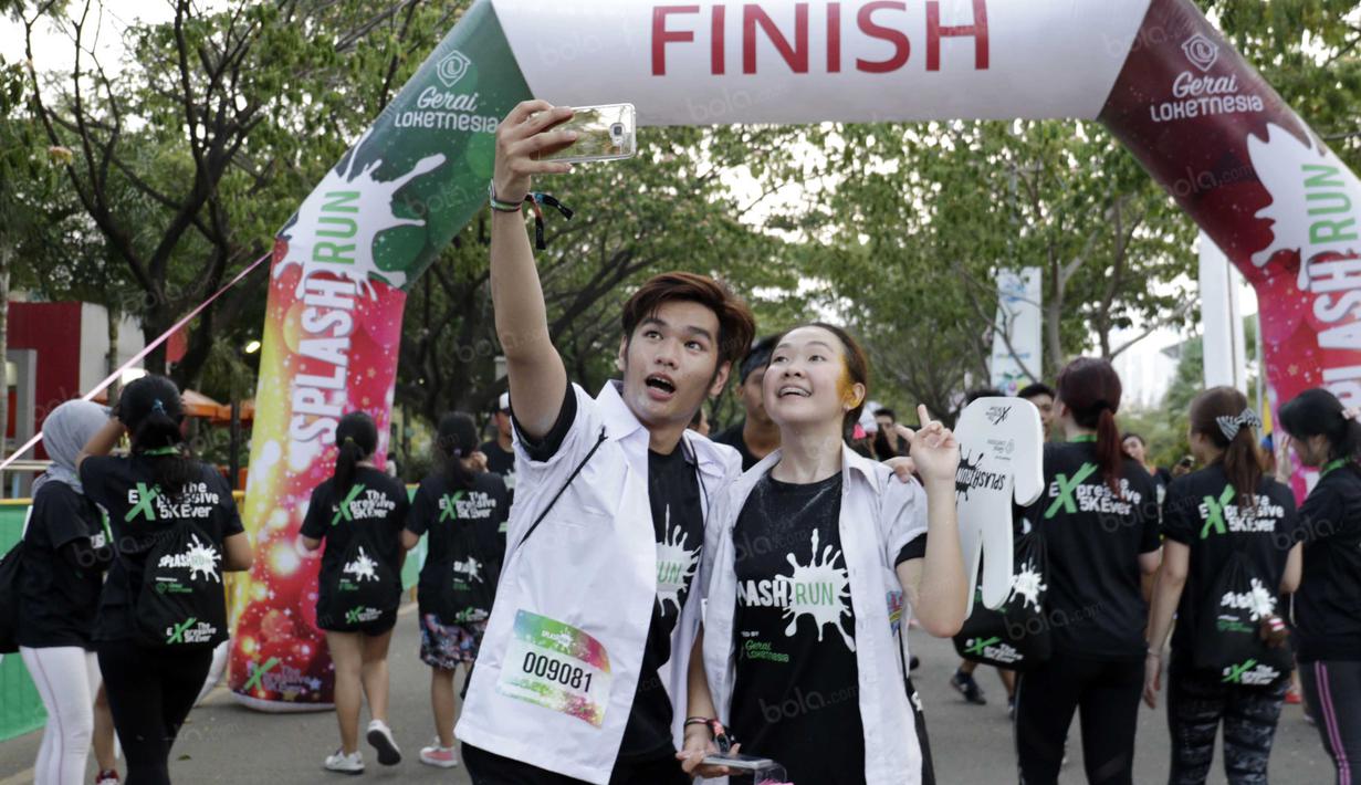 Peserta saat melakukan foto selfie saat tiba di garis finish pada ajang Splash Run di Pantai Carnaval, Ancol, Sabtu (30/7/2016). (Bola.com/Nicklas Hanoatubun)