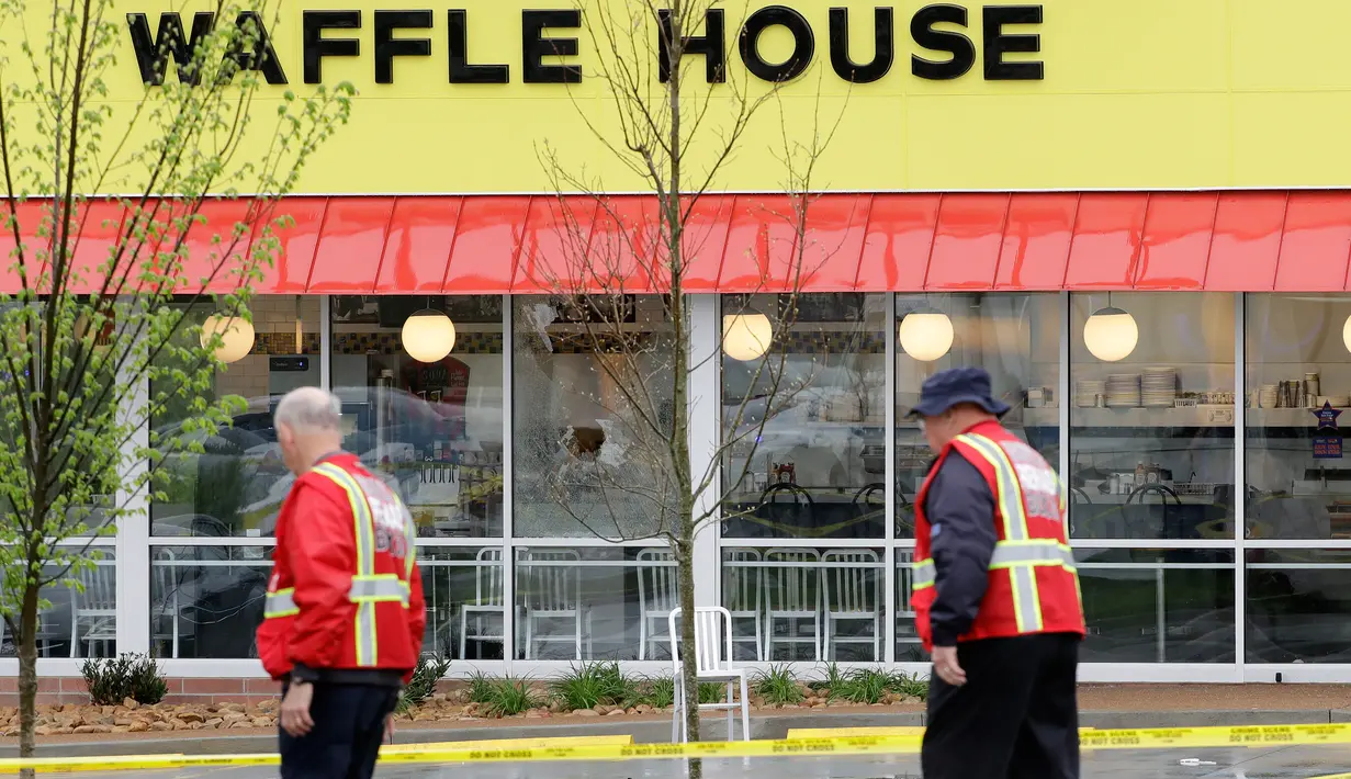 Personel darurat menyisir lokasi penembakan yang terjadi di area restoran Waffle House dekat Nashville, Tennessee, Minggu (23/4). Kasus penembakan ini menambah daftar panjang kasus-kasus penembakan maut di negeri Paman Sam. (AP Photo/Mark Humphrey)