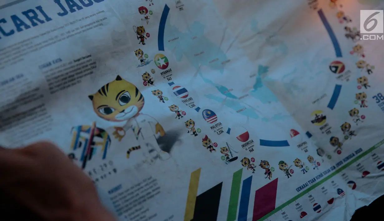 Surat kabar Malaysia, Metro Ahad, menampilkan infografis terkait 11 negara peserta SEA Games 2017 di Kuala Lumpur, Minggu (20/8). Di artikel berjudul 'Mencari Jagoan', bendera Indonesia tercetak putih-merah, bukan merah-putih. (Liputan6.com/Faizal Fanani)