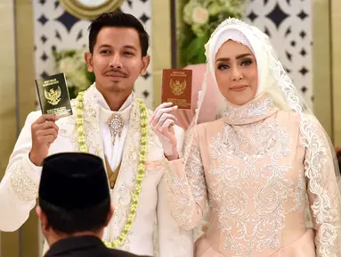 Pasangan selebritis, Fairuz A Rafiq dan Sonny Septian menunjukan buku nikah usai melangsungkan ijab kabul di kawasan Kuningan, Jakarta Selatan, Minggu (21/5). Sonny memberi mahar unik berupa uang tunai Rp 999.999. (Liputan6.com/Herman Zakharia)