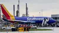 Pesawat Southwest Airlines mendarat darurat di Bandara Internasional Philadelphia, Selasa (17/4). Mesin pesawat tiba-tiba meledak saat penerbangan dari New York menuju Dallas yang membuat jendela pecah. (David Maialetti/The Philadelphia Inquirer via AP)