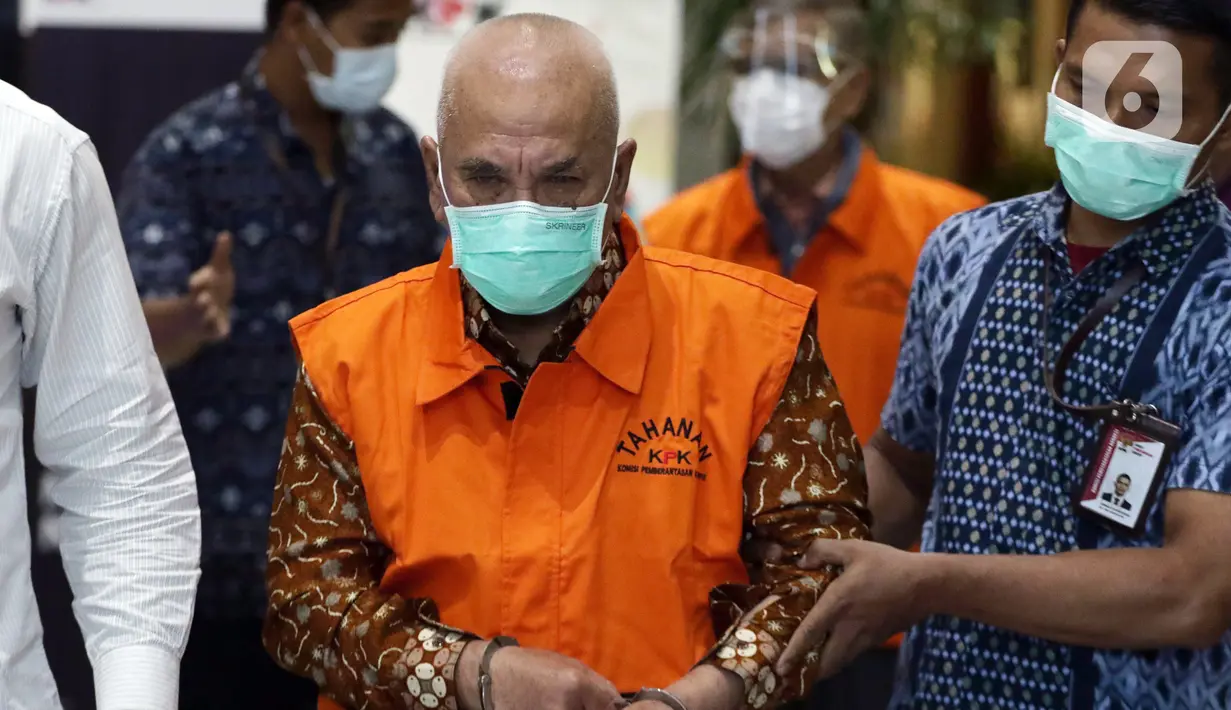 Wali Kota Banjar 2003-2008 dan 2008-2013, Herman Sutrisno (tengah) usai rilis penahanan di Gedung KPK, Jakarta, Kamis (23/12/2021). Herman Sutrisno merupakan tersangka dugaan korupsi proyek infrastruktur Kota Banjar tahun 2008-2013 dan dugaan penerimaan gratifikasi. (Liputan6.com/Helmi Fithriansyah)