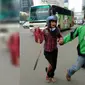 Seorang Gojek driver tampak menyelamatkan seorang perempuan dengan kaki terluka dari lokasi kejadian Sarinah