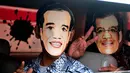 Dalam aksi tersebut, para relawan membagikan topeng Jokowi dan bunga mawar kepada pengendara motor yang melintas, Jakarta, (17/10/14). (Liputan6.com/Johan Tallo)