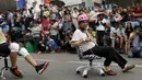 Seorang peserta ambil bagian berlari menggunakan kursi kantor dalam kompetisi ISU-1 Grand Prix di Tainan, Taiwan Selatan, Minggu (24/4/2016).  (REUTERS/Tyrone Siu)