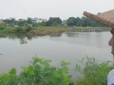 Seorang warga tampak melihat Waduk Giri Kencana, Cilangkap, Jakarta Timur, Rabu (18/2/2015). Menurut Pemprov DKI, belum digarapnya pembangunan waduk karena terkendala pembebasan lahan. (Liputan6.com/Herman Zakharia)