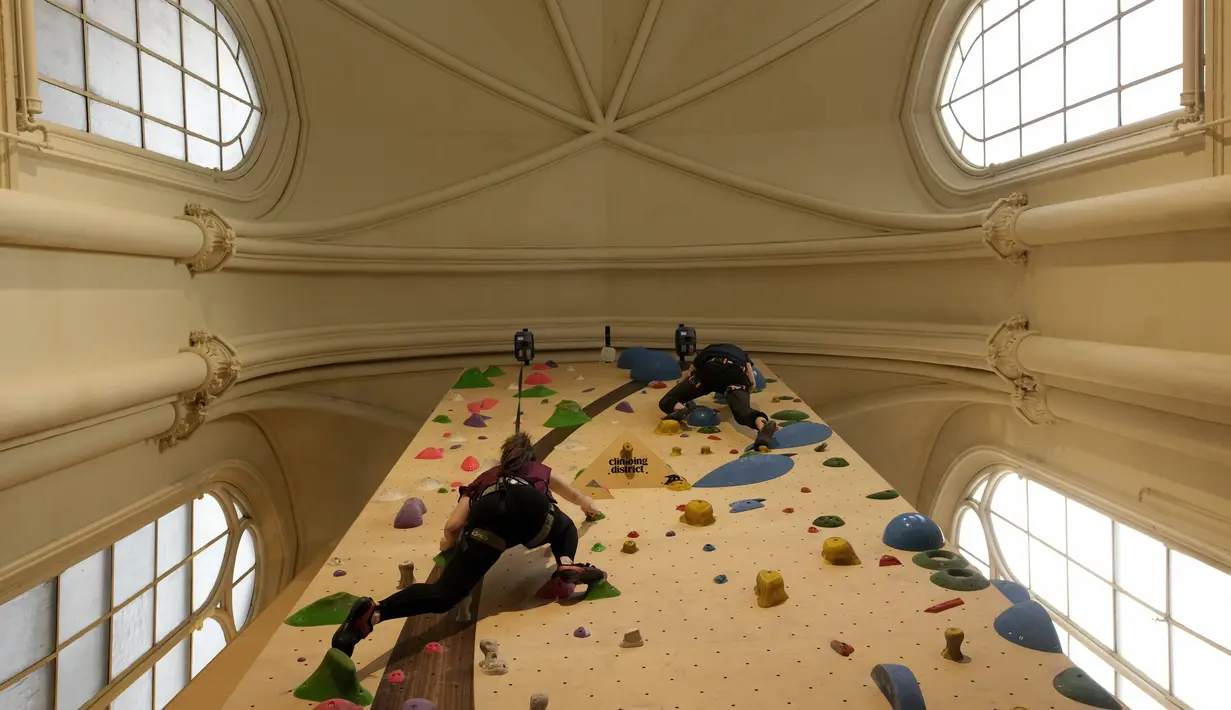 Peserta berlatih memanjat di lokasi Climbing District di Paris, Rabu, 11 Januari 2023. Tembok panjat buatan baru ini dibuka pada November 2022 di dalam bekas kapel abad ke-19, bernama le couvent des Oblats de Marie-Immaculee. (AP Photo/Christophe Ena)
