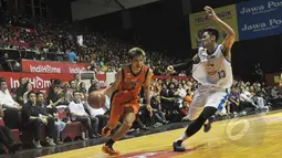 Pemain Pelita Jaya Energi-MP Chandra Ary berusaha melewati hadangan dari pemain Satria Muda Britama, Gunawan  pada laga NBL Championship, Jakarta, Minggu (10/5). Satria Muda Britama unggul 62-54 atas Pelita Jaya Energi-MP (Liputan6.com/Herman Zakharia)