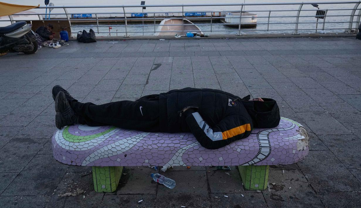 Situasi ini untuk menghindari serangan udara Israel yang mengancam tempat tinggal mereka. Tampak dalam foto, seorang pria pengungsi yang melarikan diri dari serangan udara Israel di Dahiyeh, pinggiran selatan Beirut, beristirahat di tepi pantai Beirut, Lebanon, Jumat 6 Maret 2026. (AP Photo/Hussein Malla)