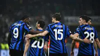 Para pemain Inter Milan merayakan gol yang dicetak Hakan Calhanoglu ke gawang Feyenoord pada leg 2 16 besar Liga Champions 2024/2025 di Giuseppe Meazza, Rabu (12/3/2025) dini hari WIB. (Isabella BONOTTO / AFP)