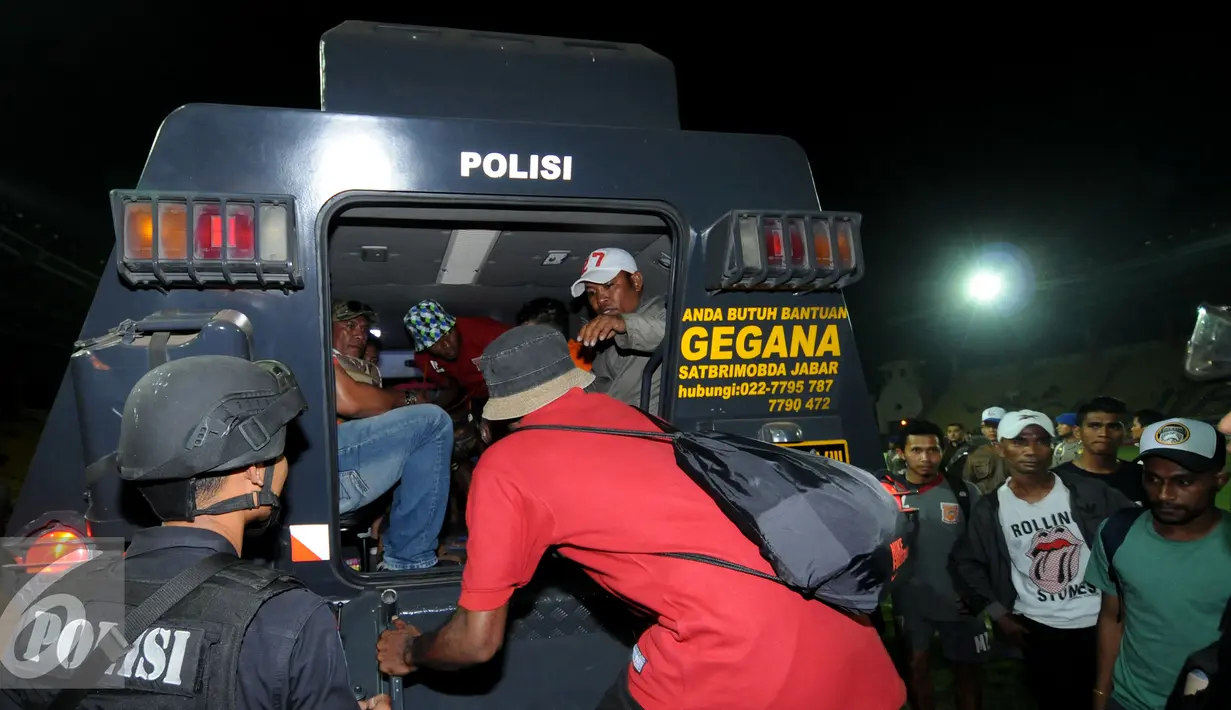 Seorang personil Brimob mengawal skuat PBFC yang akan masuk kedalam kendaraan taktis usai laga melawan Persib di Stadion Si Jalak Harupat, Bandung, Sabtu (26/9/2015). PBFC kalah 1-2 dari Persib. (Liputan6.com/Helmi Fithriansyah)