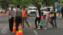 Petugas polisi saat berjaga di jalan sekitar Gereja Santo Laurensius, Alam Sutra, Tangerang, Kamis (24/12). Anggota kepolisian dan TNI berjaga disekitaran gereja untuk menanggulangi hal - hal yang tidak diinginkan. (Liputan6.com/Faisal R Syam)