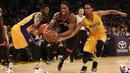 Pemain Toronto Raptors, DeMar DeRozan (tengah) berusaha melewati para pemain Los Angeles Lakers pada lanjutan NBA di  Staples Center, Sabtu (21/11/2015). (Reuters/Mandatory Credit: Kelvin Kuo-USA TODAY Sports)