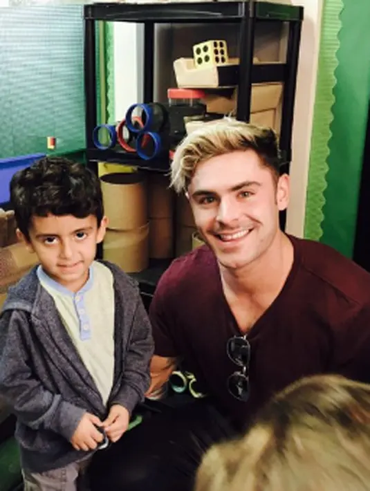 Dalam foto tersebut, Zac Efron sedang asyik menikmati suasana berkumpul bersama beberapa anak kecil. (twitter/Bintang.com)