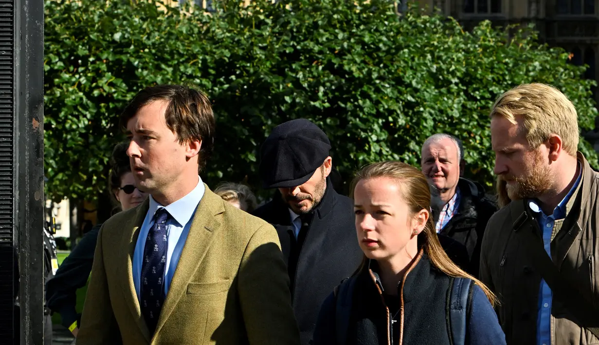 David Beckham tertangkap kamera tengah mengantre bersama para pengunjung lain di jalan-jalan Kota London untuk memberikan penghormatan terakhir kepada Sang Ratu di Westminster Hall yang merupakan bagian dari Istana Westminster, London. (AFP/Louisa Gouliamaki)