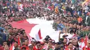 Anggota TNI POLRI  bersama warga masyarakat membawa bendera raksasa berukuran panjang 117 meter dan lebar 5 meter saat gelaran Festival Merah-Putih (FMP) 2018 di kawasan Air Mancur, Bogor ,  Minggu (5/8). (Merdeka.com/Arie Basuki)