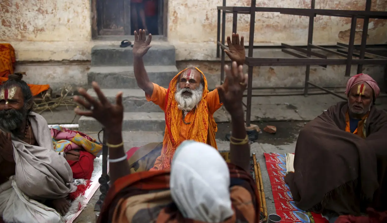 Orang suci dalam kepercayaan Hindu atau disebut sadhus berdoa di Kuil Pashupatinath, Kathmandu , Nepal, (6/3). Para Sadhus merayakannya dengan berdoa , merokok ganja atau mengolesi tubuh mereka dengan abu . (REUTERS / Navesh Chitrakar)